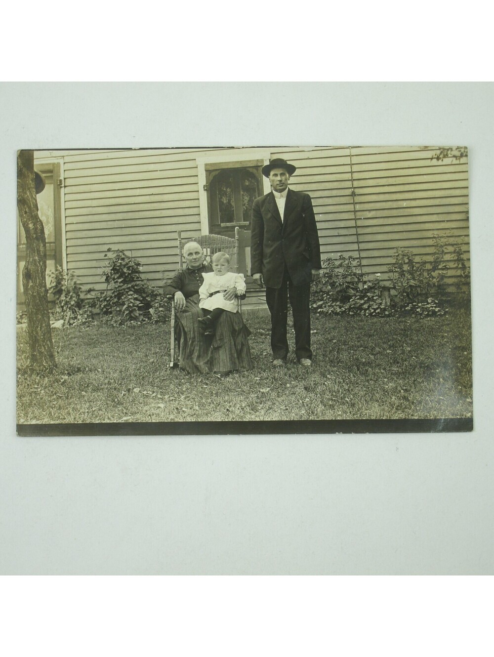RPPC Photo Postcard Family Outside House Man Woman Baby in Chair Antique c 1910